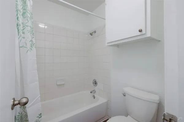 a bathroom with a bathtub and a toilet