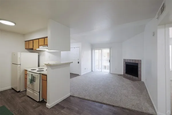 a kitchen with a stove top oven and cabinets