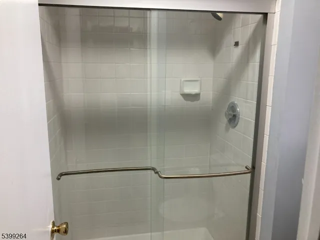 a bathroom with a glass shower door