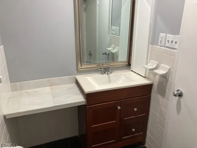 a bathroom with a sink vanity and a mirror