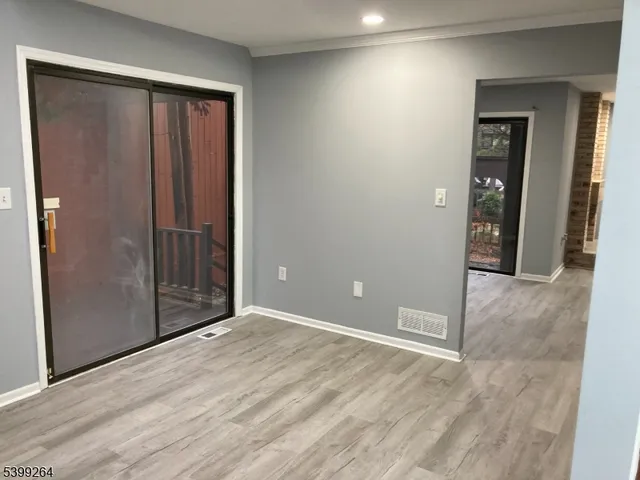 an empty room with closet and mirror