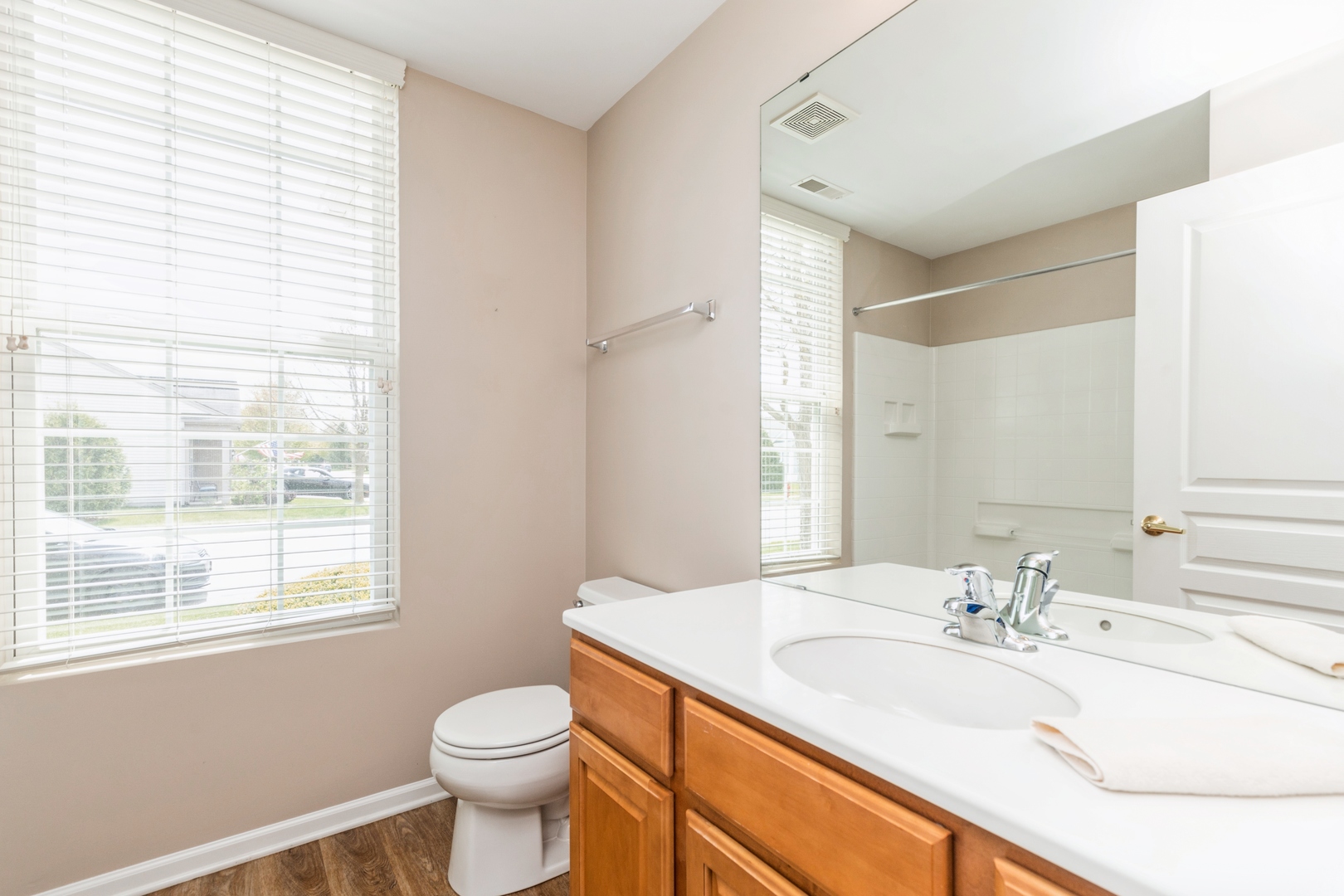 13472 Delaney Road Huntley, IL 60142 - Photo 14 of 16 a bathroom with a granite countertop sink toilet and large mirror