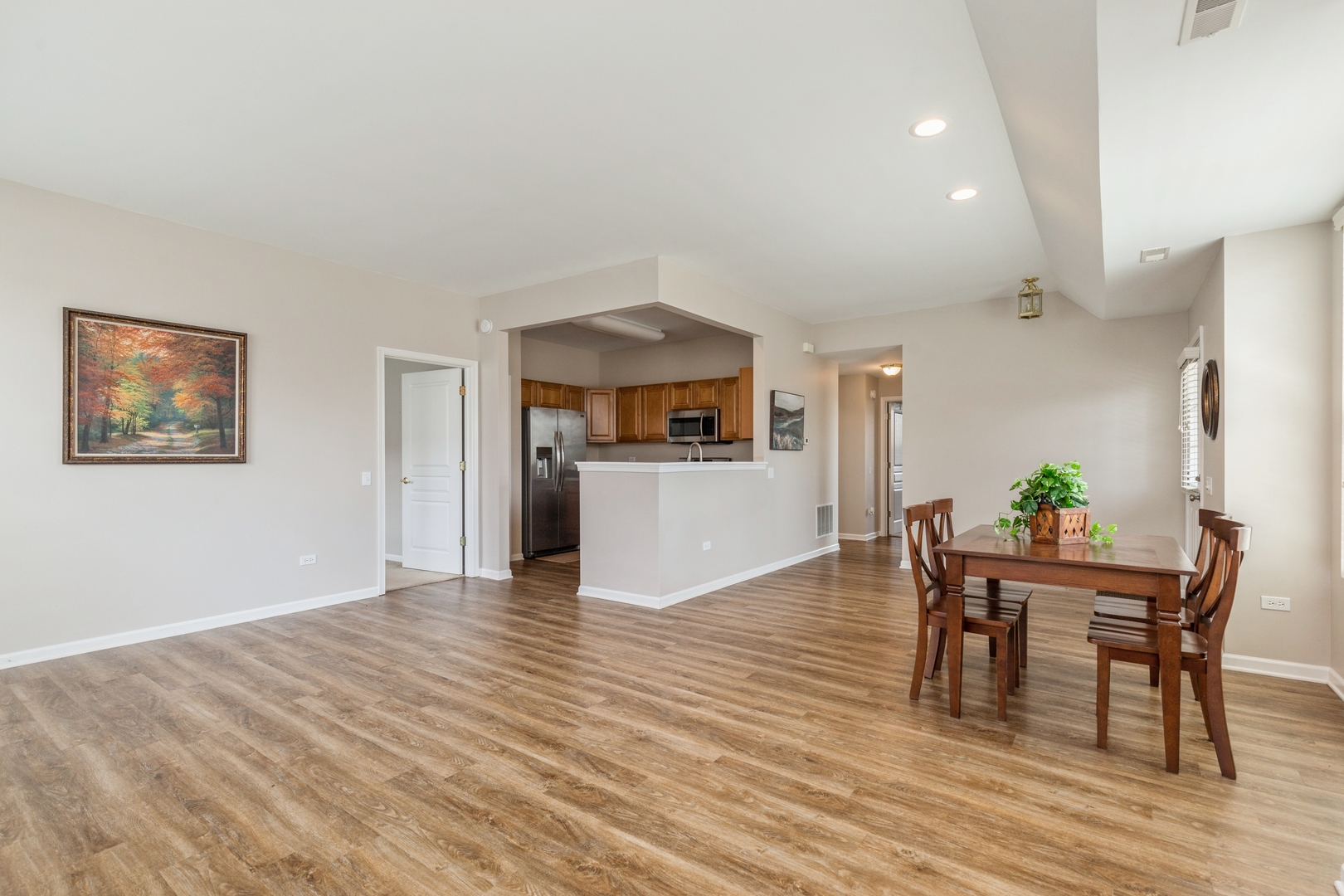 13472 Delaney Road Huntley, IL 60142 - Photo 6 of 16 a view of a dining room with furniture and wooden floor