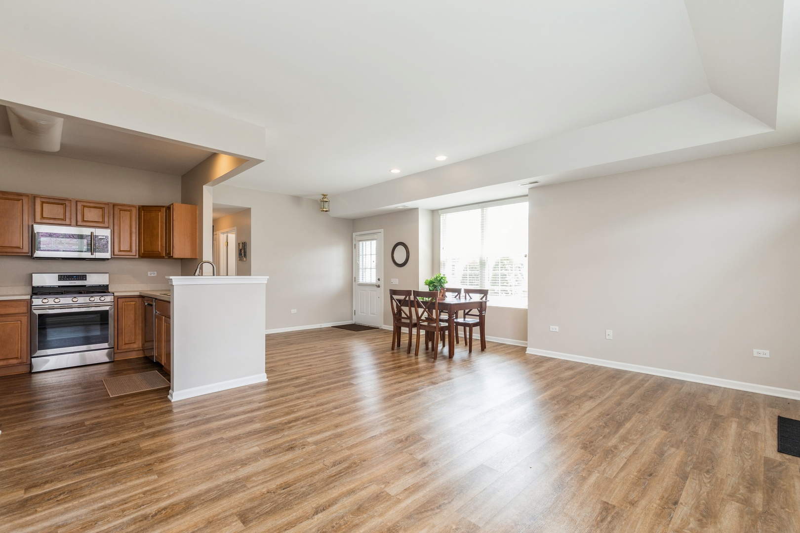 13472 Delaney Road Huntley, IL 60142 - Photo 7 of 16 a view of a kitchen with microwave and furniture