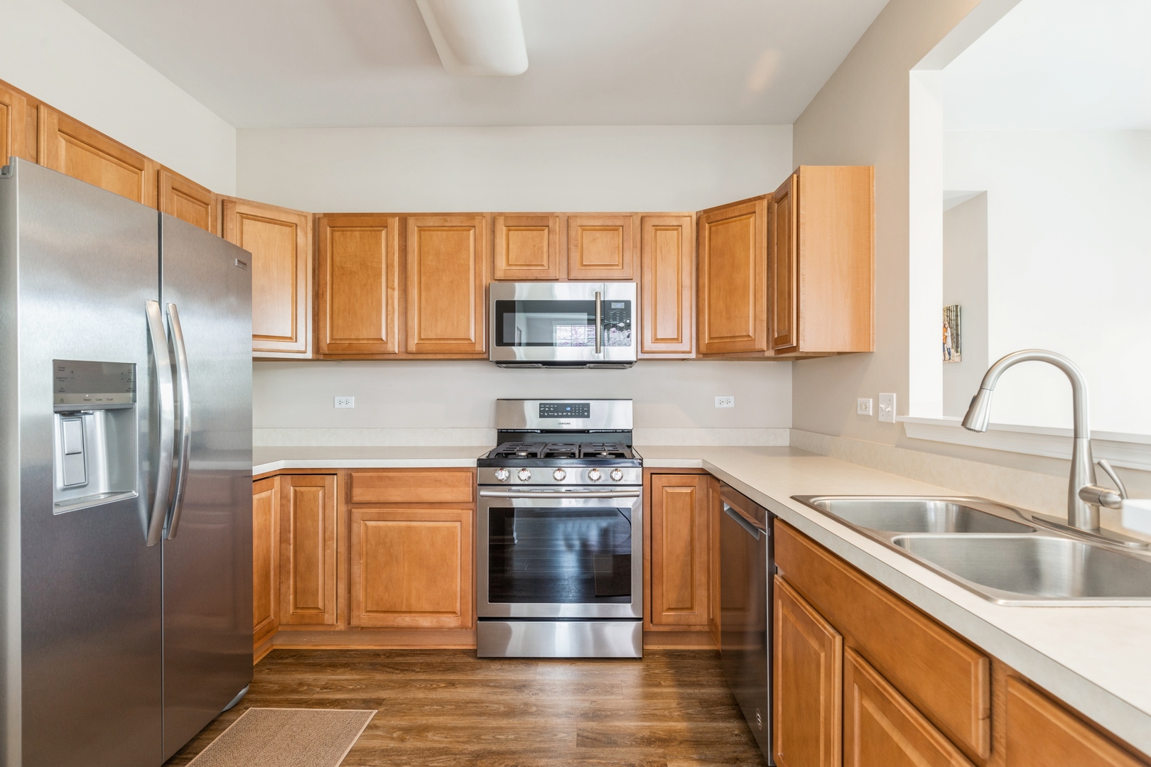 13472 Delaney Road Huntley, IL 60142 - Photo 8 of 16 a kitchen with stainless steel appliances granite countertop a stove a sink and a refrigerator with wooden cabinets