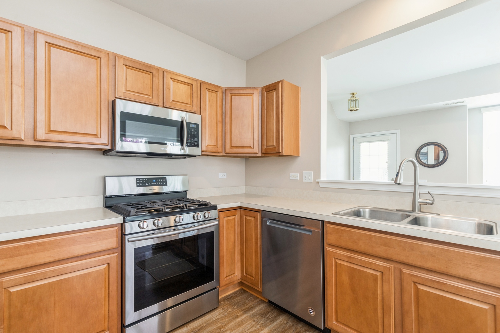 13472 Delaney Road Huntley, IL 60142 - Photo 10 of 16 a kitchen with granite countertop a sink cabinets stainless steel appliances and a window