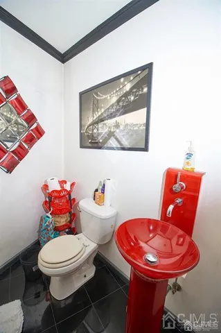 a bathroom with a toilet a sink and a mirror