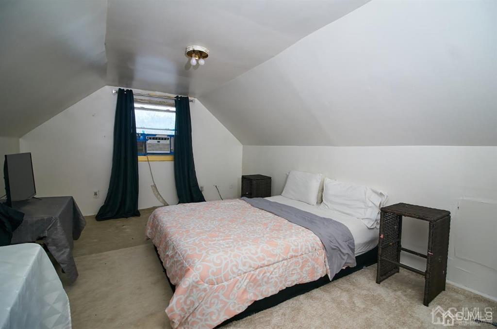 1610 Oak Tree Road Iselin, NJ 08830 - Photo 14 of 17 a bedroom with a bed and a mirror