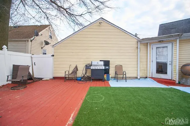 a view of a backyard with chairs and a table