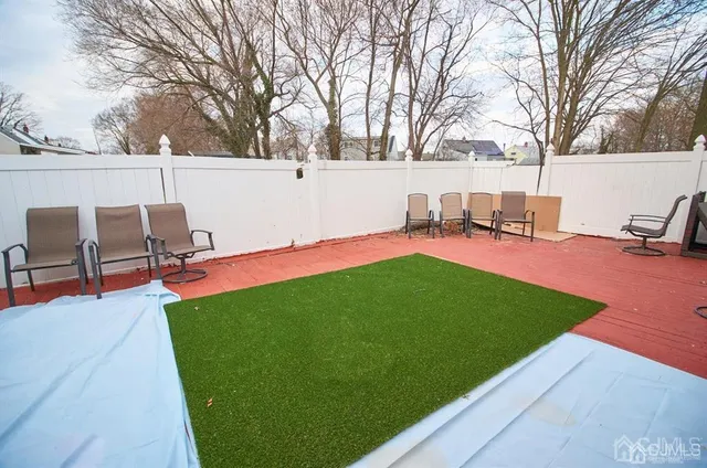 a view of backyard with seating area and trees