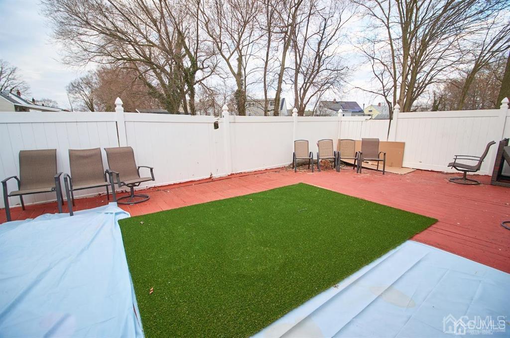 1610 Oak Tree Road Iselin, NJ 08830 - Photo 16 of 17 a view of backyard with seating area and trees
