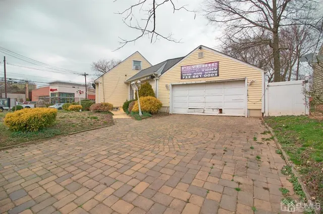 a view of garage with wooden fence