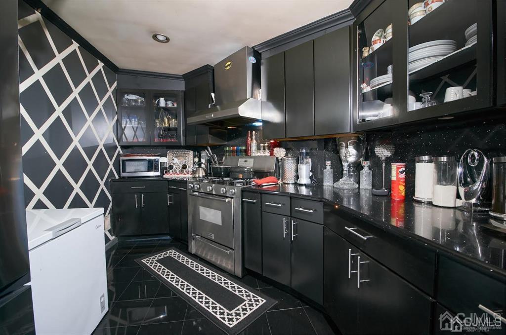 1610 Oak Tree Road Iselin, NJ 08830 - Photo 7 of 17 a kitchen with a stove and a refrigerator