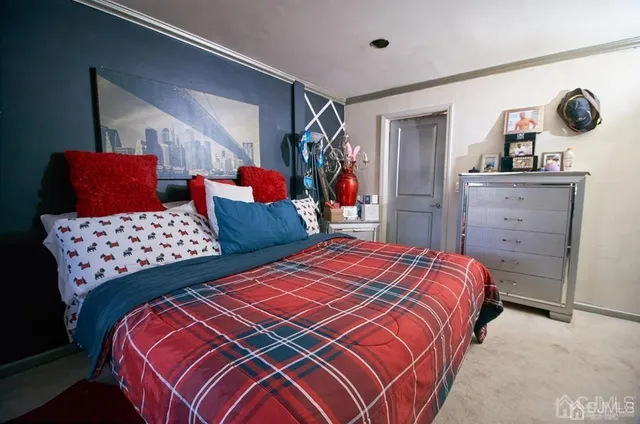 a bedroom with double bed and a dresser