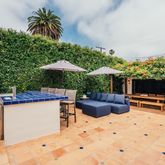 a view of a lounge chairs in patio and swimming pool
