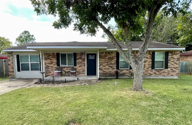 a view of a house with backyard porch and sitting area