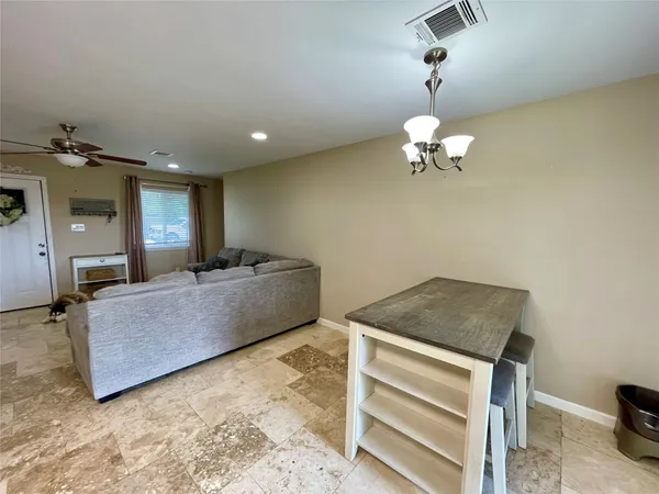 a living room with a couch and chandelier