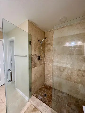 a bathroom with a shower and a sink