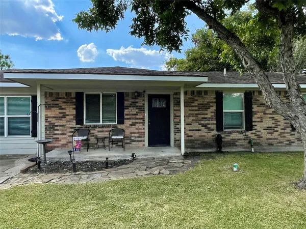 a view of house with backyard space and garden