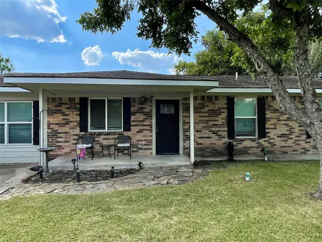a view of house with backyard space and garden