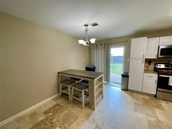 a room with furniture a chandelier a fireplace and a chandelier