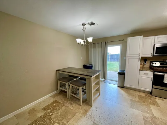 a room with furniture a chandelier a fireplace and a chandelier