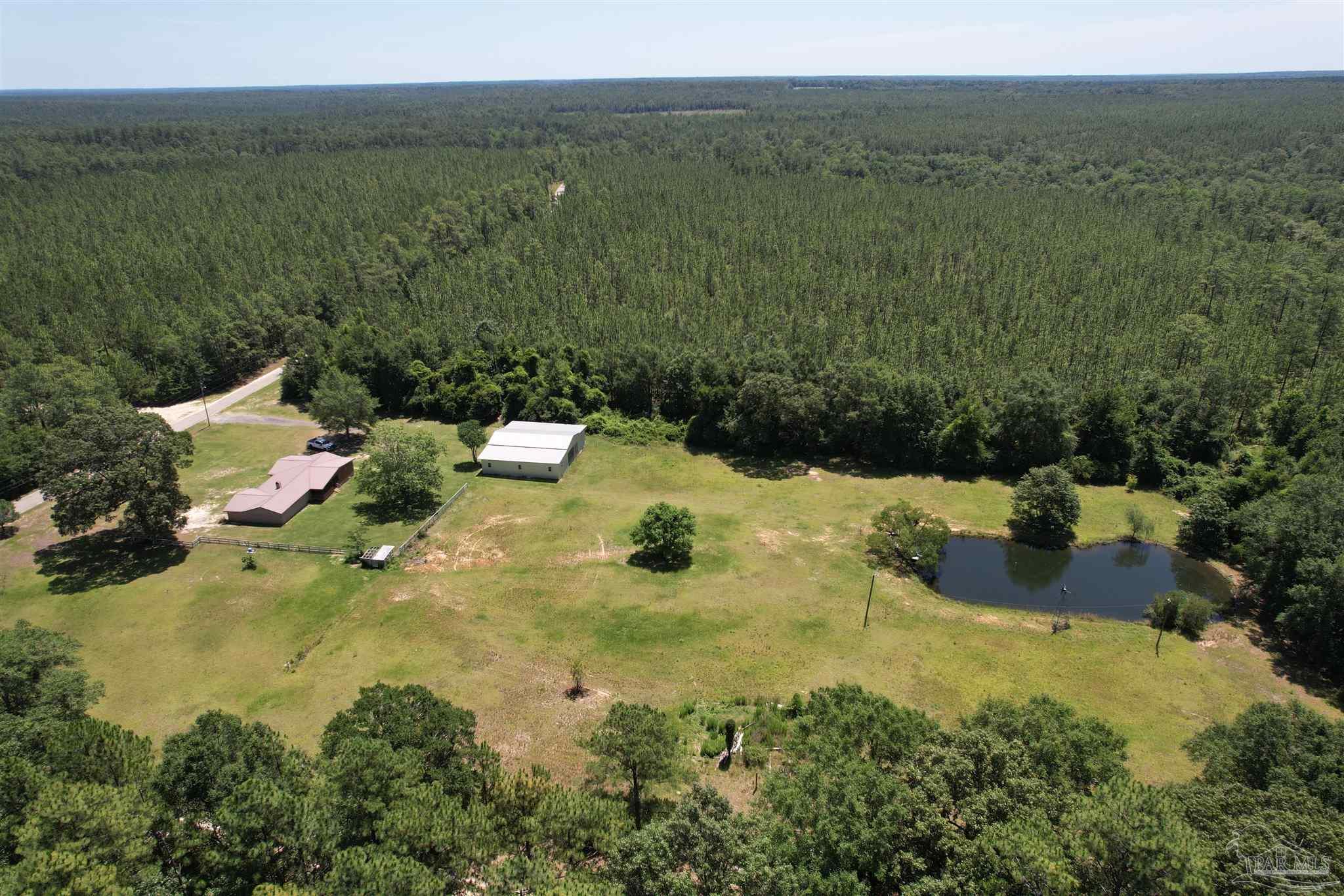 9353 Sellersville Road Jay, FL 32565 - Photo 14 of 26 a view of a lake with a mountain
