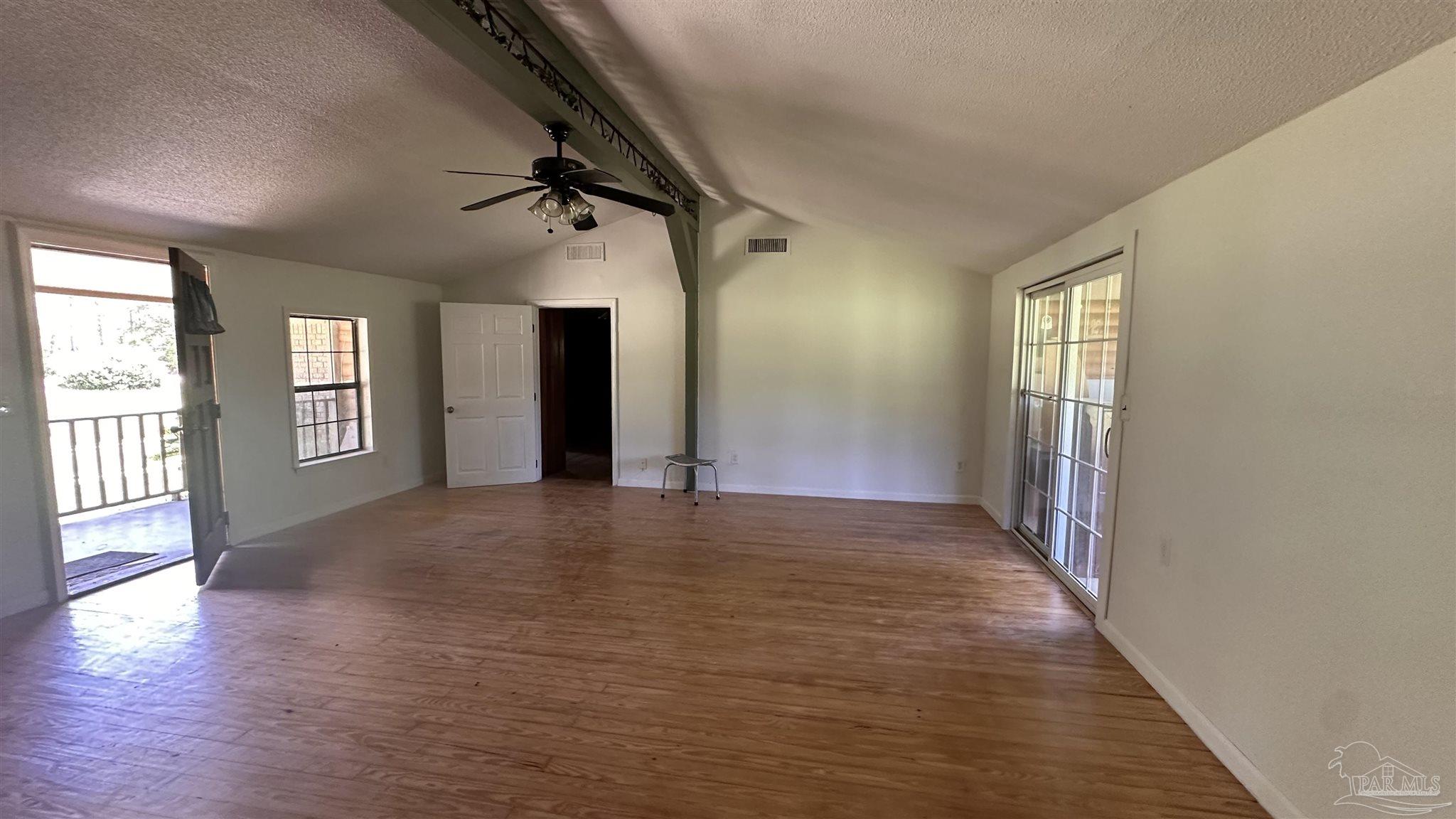 9353 Sellersville Road Jay, FL 32565 - Photo 19 of 26 an empty room with wooden floor and windows