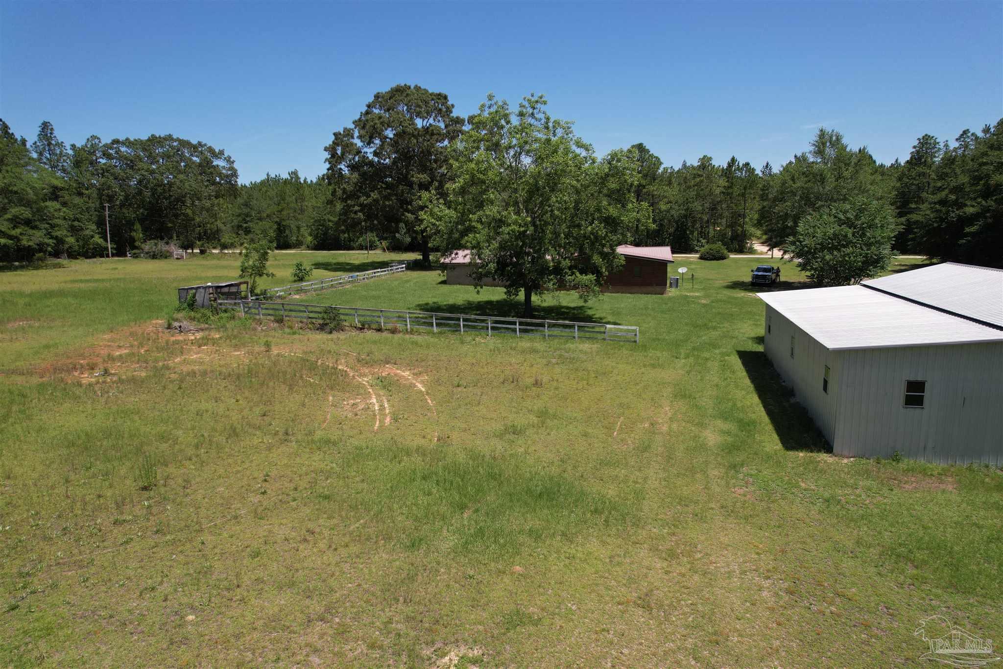9353 Sellersville Road Jay, FL 32565 - Photo 21 of 26 a backyard of a house with lots of green space