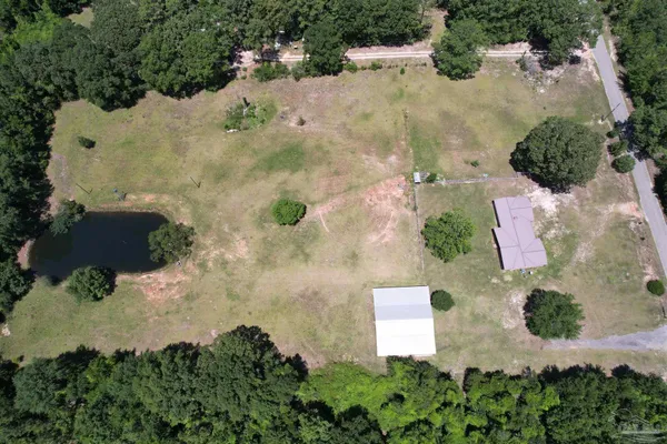 an aerial view of a house with a yard