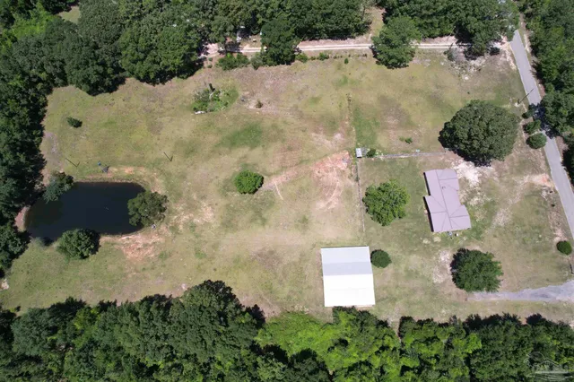 an aerial view of a house with a yard