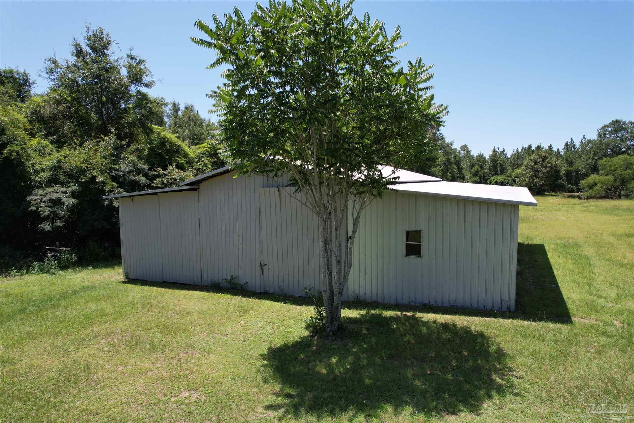 9353 Sellersville Road Jay, FL 32565 - Photo 6 of 26 a backyard of a house with lots of green space