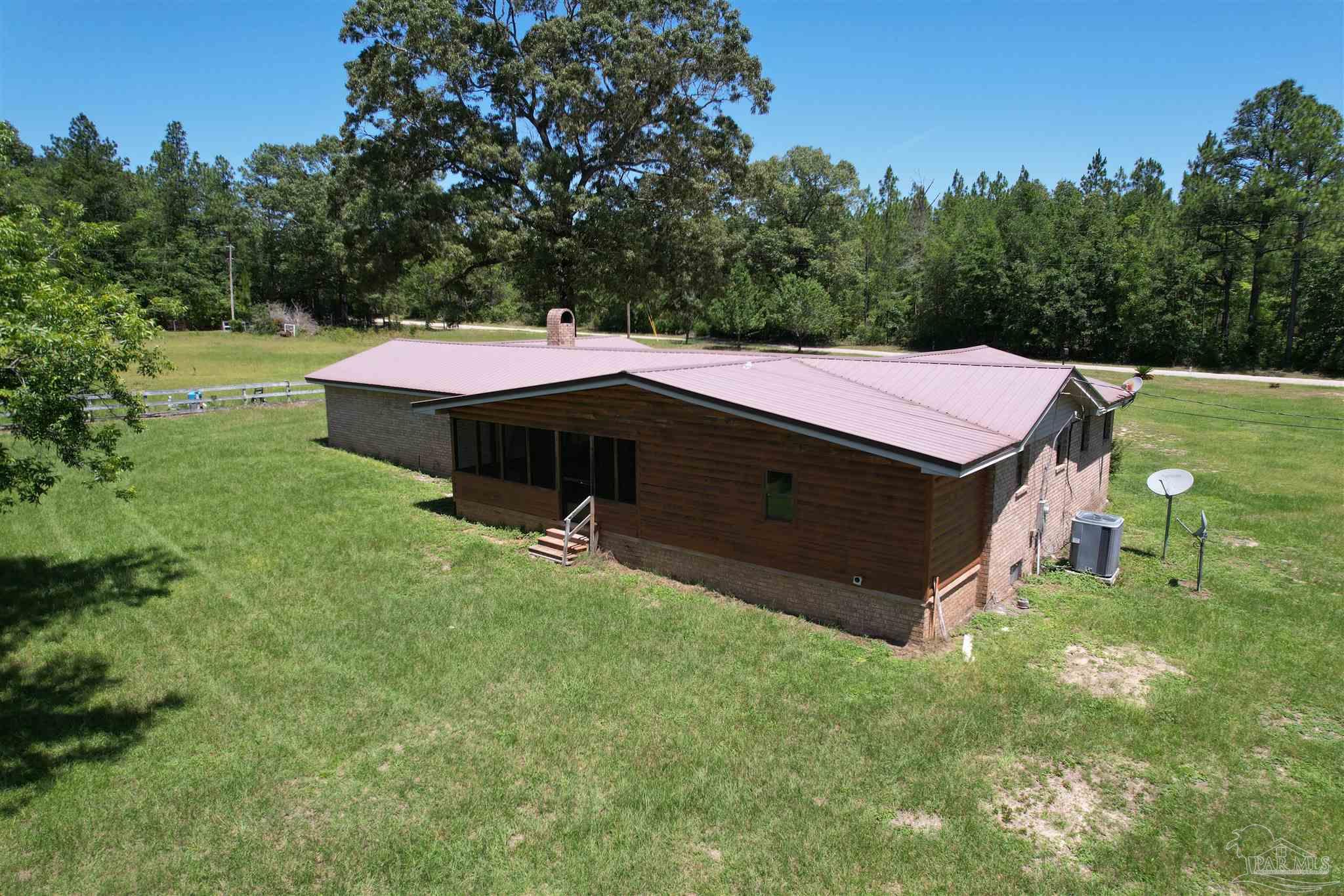 9353 Sellersville Road Jay, FL 32565 - Photo 7 of 26 a backyard of a house with table and chairs