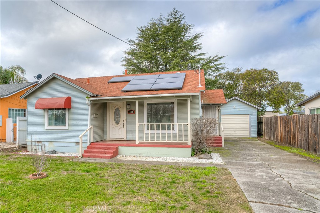 1568 Link Street Corning, CA 96021 - Photo 1 of 28 a front view of a house with a garden