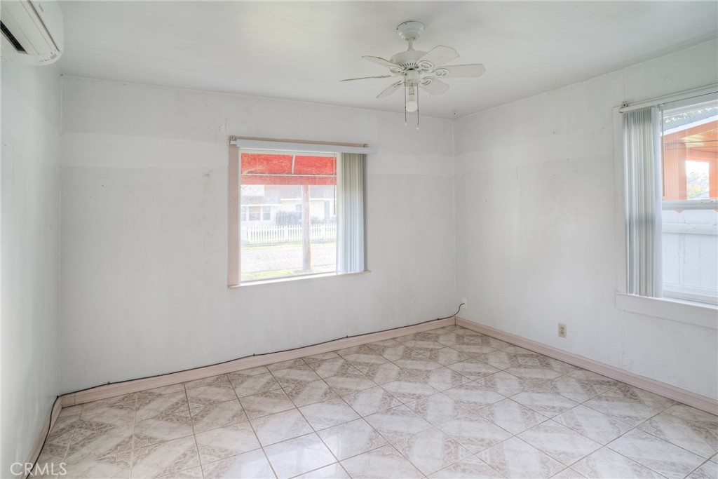 1568 Link Street Corning, CA 96021 - Photo 14 of 28 a view of a big room with windows and chandelier fan