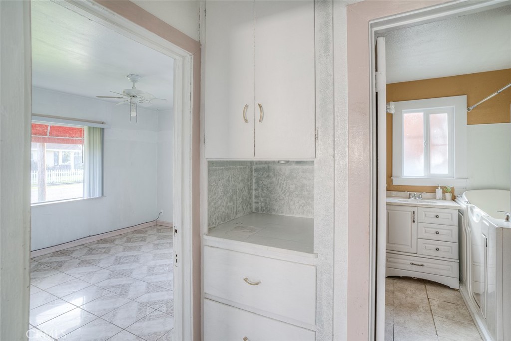 1568 Link Street Corning, CA 96021 - Photo 16 of 28 a bathroom with a granite countertop sink a mirror and a shower