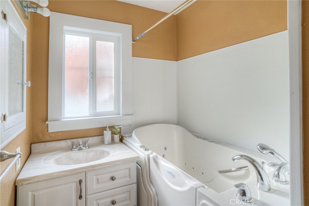 1568 Link Street Corning, CA 96021 - Photo 17 of 28 a bathroom with a sink and a bathtub
