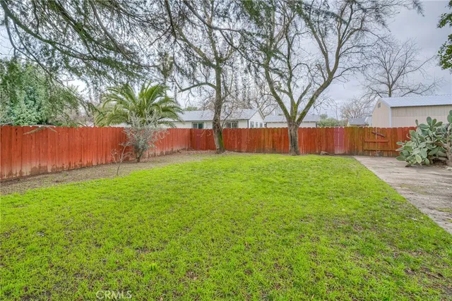a backyard of a house with yard table and chairs