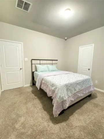 a bedroom with a bed and a television