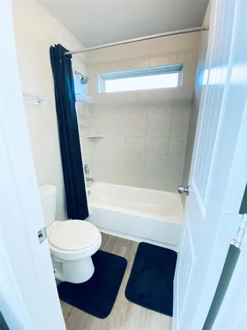 a large room with a bed and a flat screen tv