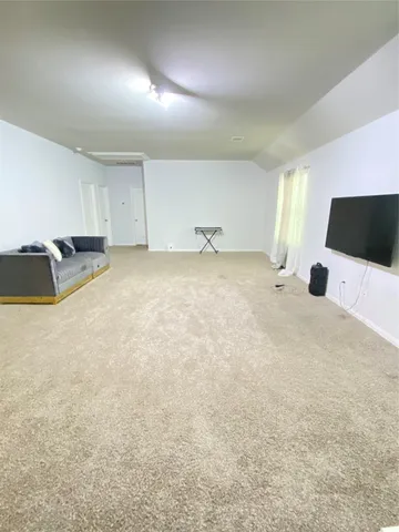 a view of a house with a yard and sitting area