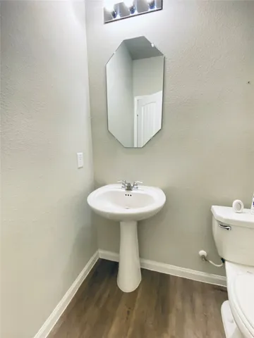 a view of a house with backyard and wooden fence
