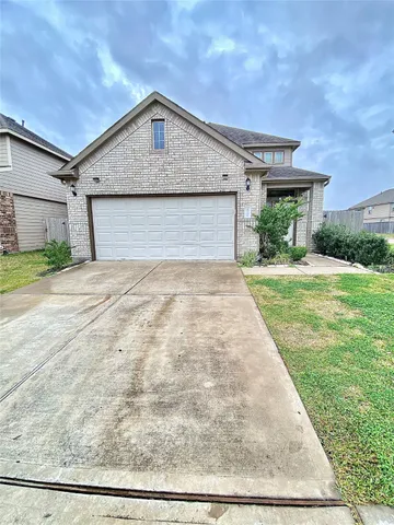 a stone house with potted plants in front of door