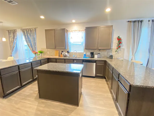 a kitchen with stainless steel appliances wooden cabinets and a stove