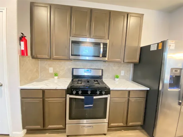 a spacious bedroom with a bed and a flat screen tv