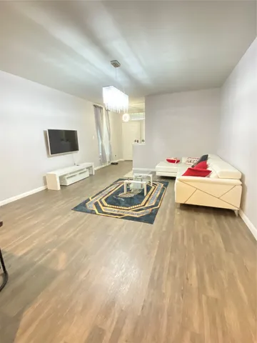 a bedroom with a large bed and a chandelier