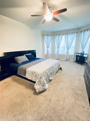 a bathroom with a granite countertop sink toilet and mirror
