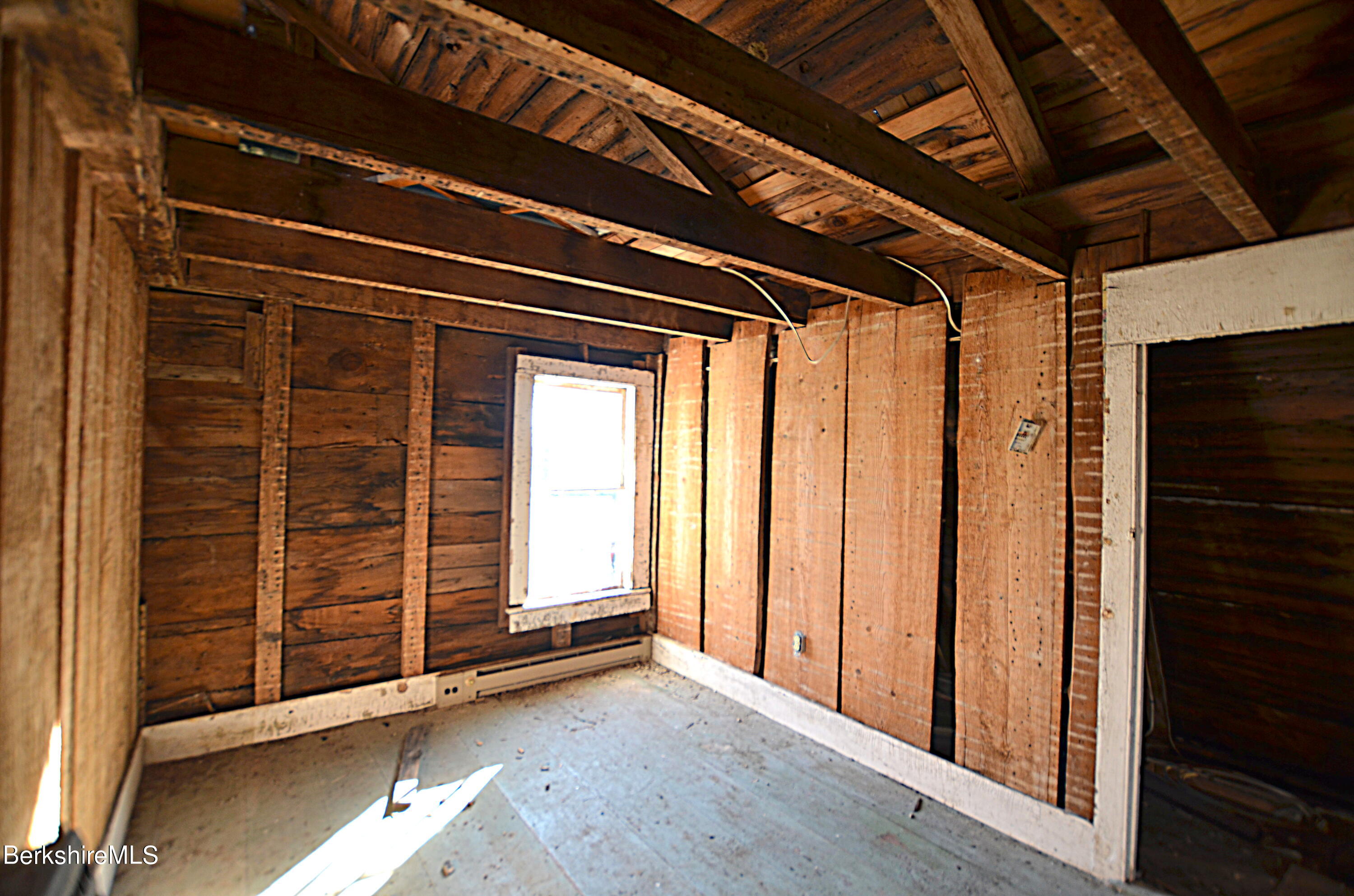 178 New Hartford Road Sandisfield, MA 01255 - Photo 21 of 62 a view of an empty room with wooden floor and a window