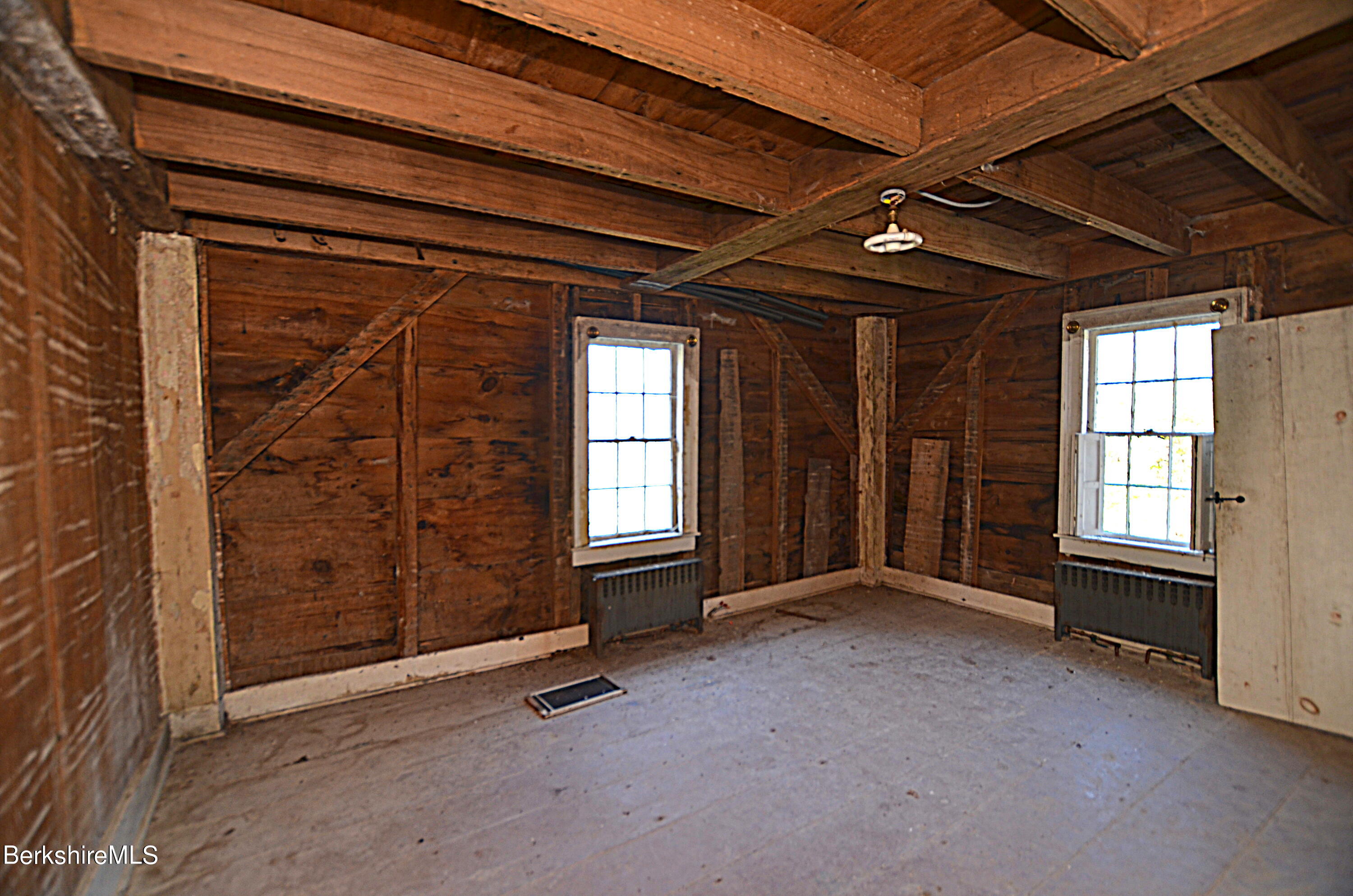 178 New Hartford Road Sandisfield, MA 01255 - Photo 23 of 62 a view of an empty room with a fireplace and a window