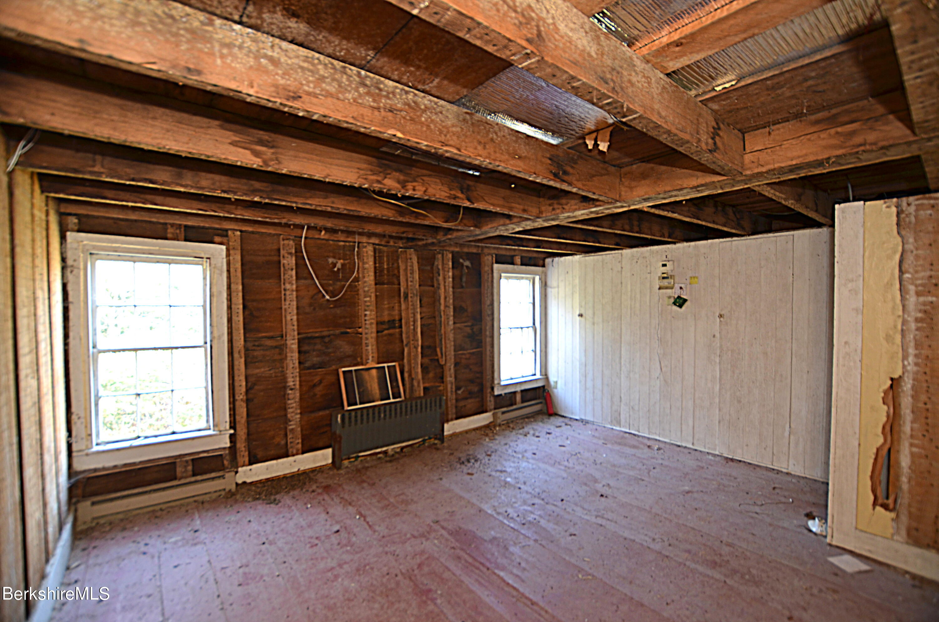 178 New Hartford Road Sandisfield, MA 01255 - Photo 27 of 62 a view of an empty room with wooden floor and a window